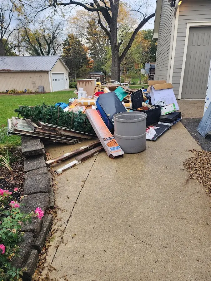 Dumpster being loaded with debris for Roofing Dumpster Rental in Krum